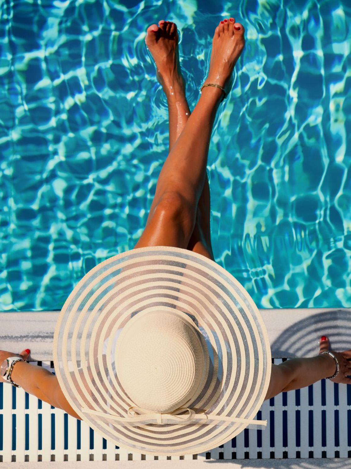 woman sitting next to pool