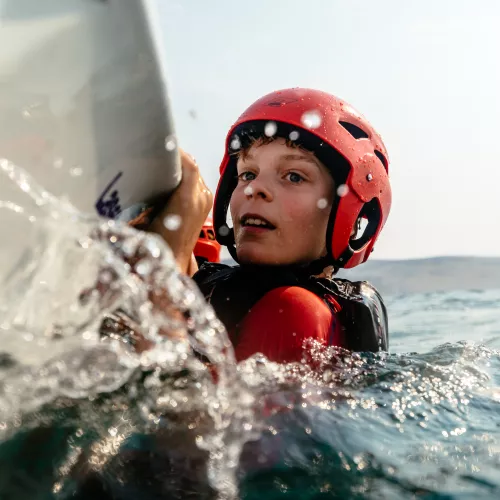 young boy dinghy sailing