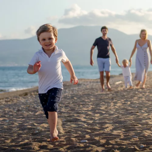 Family walking along the beach in Greece