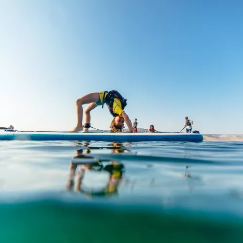 boy on a paddle board in Greece