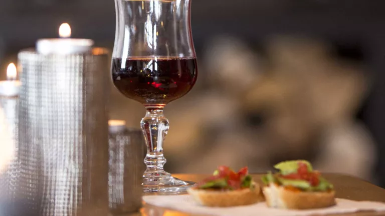 Enjoy a glass of wine by the wood burning stove