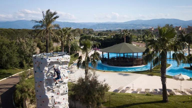 climbing wall with swimming pool in background