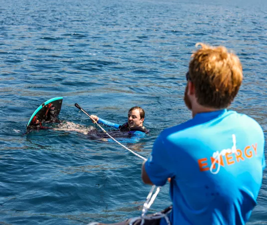 Matt Crowhurst helps instruct a wakeboarder in the water