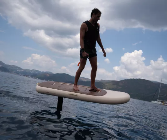 A man efoiling in a calm bay
