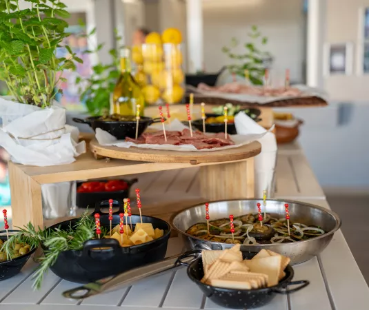 a buffet-style food setup on a white table. 