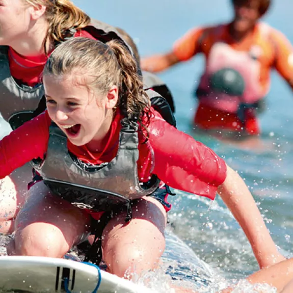 Group of children playing and splashing in sea