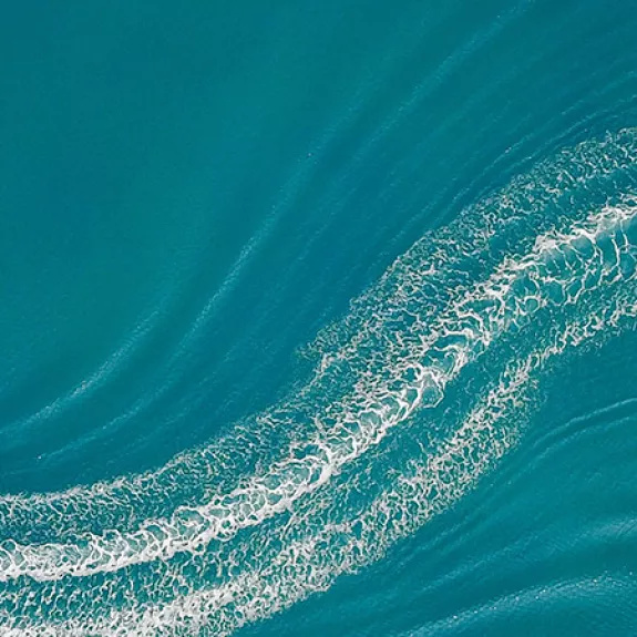 Aerial image of wakeboarder and speed boat