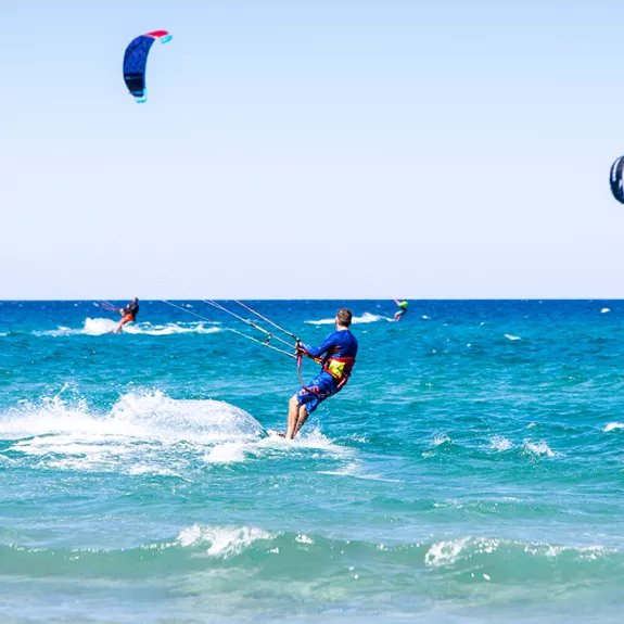 People kitesurfing on holiday in Sardinia