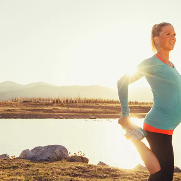 Pregnant woman stretching after a run