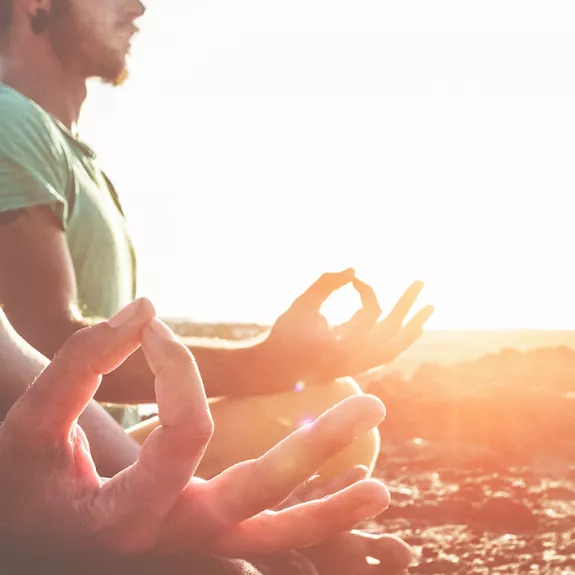 2 people doing yoga at sunset