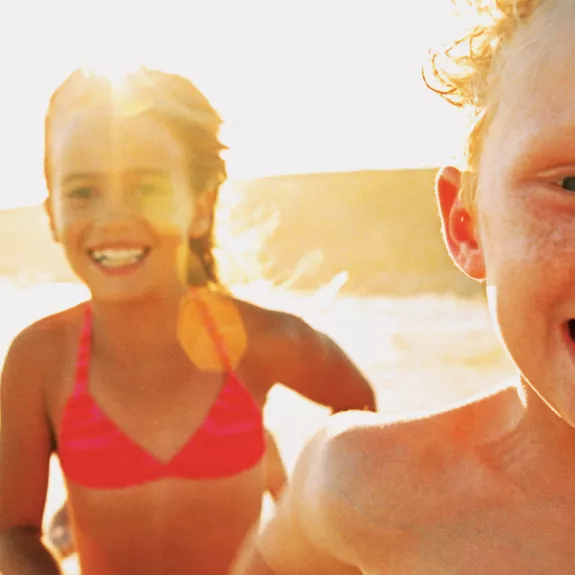 Kids running on a beach