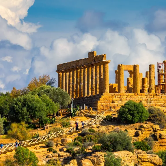 The image depicts the ancient Temple of Concordia located on a hill in the Valley of the Temples, Agrigento, Sicily. 
