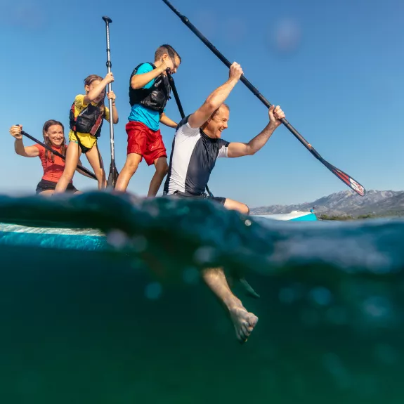 family on a paddle board