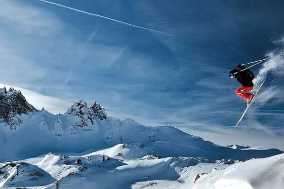 skier jumping from a Cliff drop
