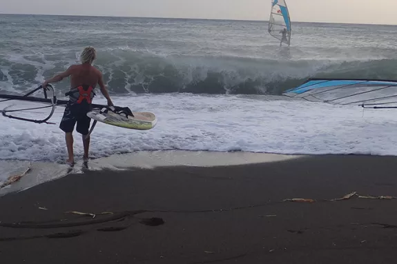 two people about to go windsurfing