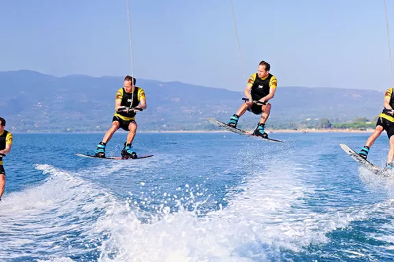 Jumping the boat wake on a wakeboard