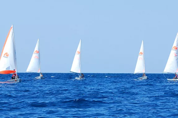 Group of people sailing dinghies