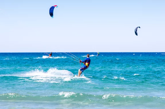 People kitesurfing on holiday in Sardinia