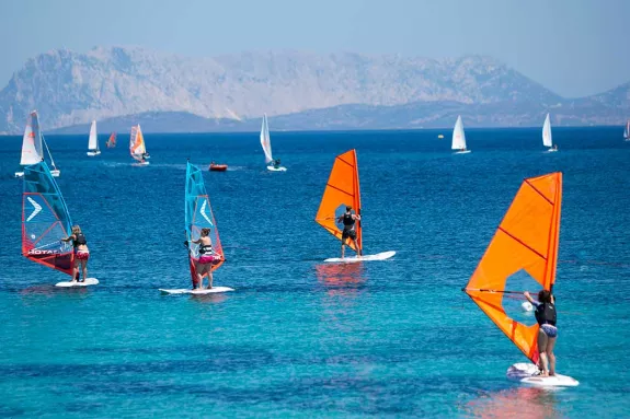 Group of beginners windsurfing
