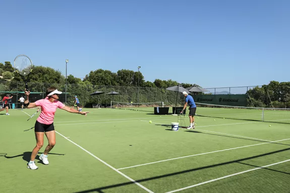 men and women paying doubles tennis