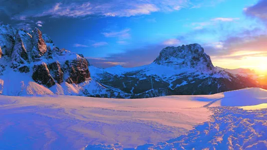 sun rise over Italian mountains covered in snow