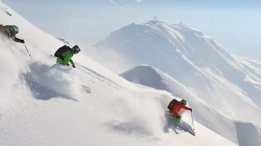 Skiers and Snowboard on a powder run