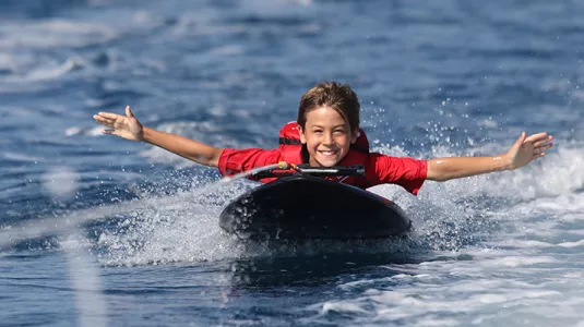 Young boy on kneeboard