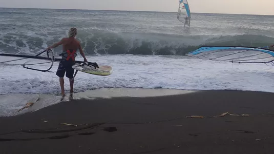 two people about to go windsurfing