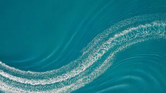 Aerial image of wakeboarder and speed boat