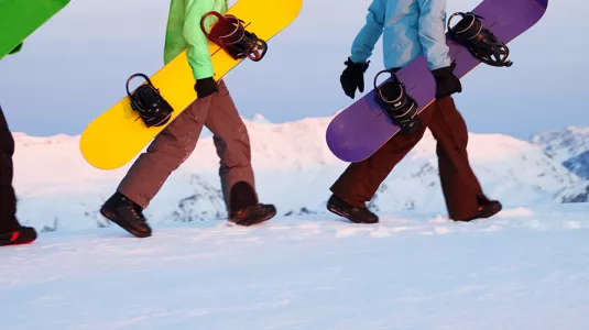 snowboarders walking with their boards
