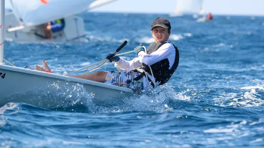 young boy dinghy sailing