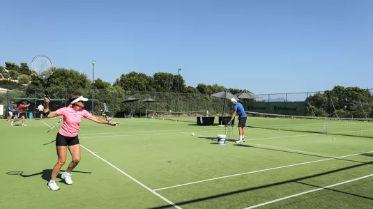 men and women paying doubles tennis