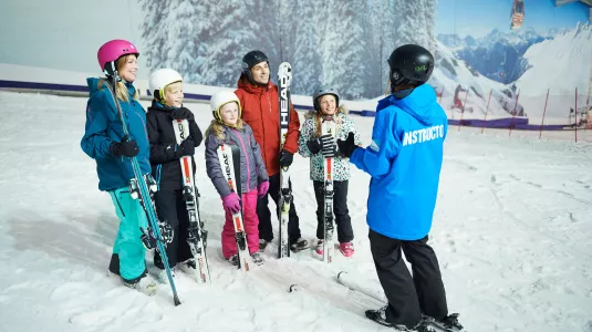 group learning to ski at indoor snow dome