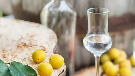 Fruits next to a glass