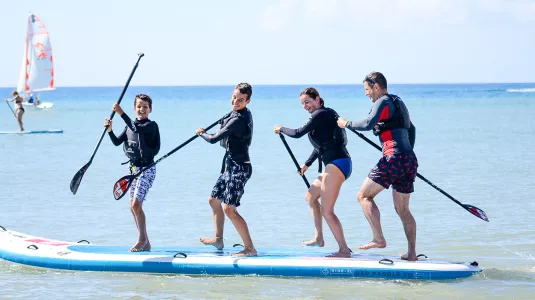 Family on a stand up paddle board