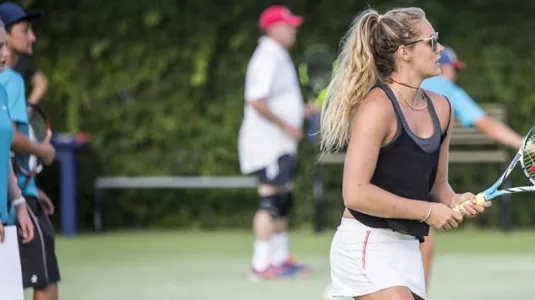 teenage girl playing tennis