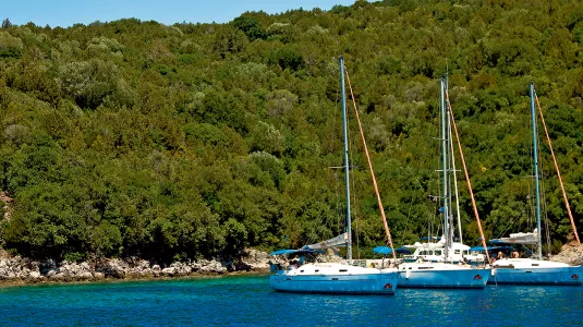three yachts moored up in a bay