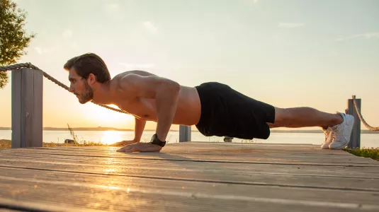 man doing push ups outdoors