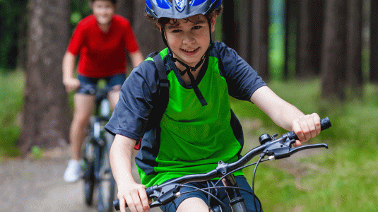 boy cycling in forest