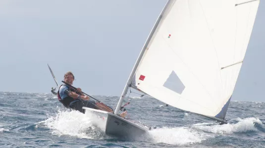 Angus sailing a Laser