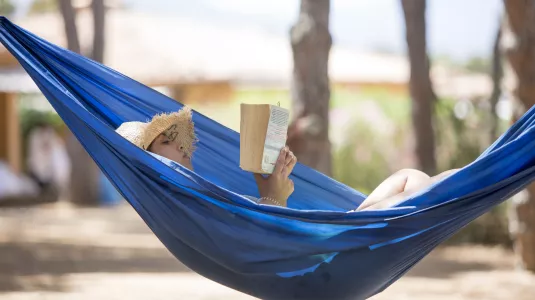 Reading a book in a hammock