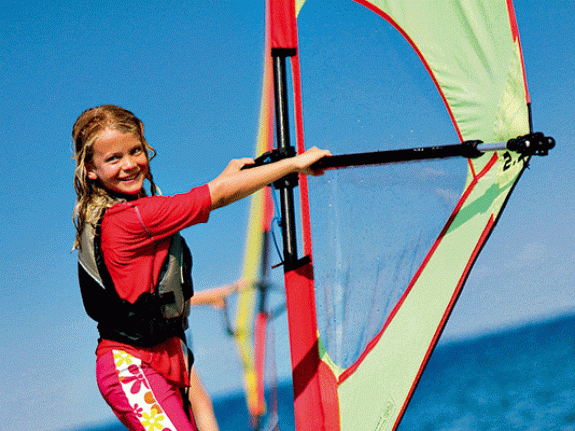 young girl windsurfing