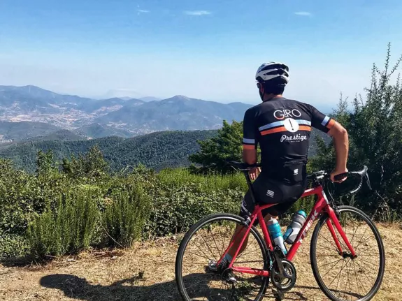 man on road bike